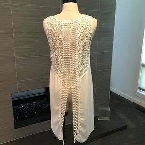 Sheer, white, high-low top with crochet details.